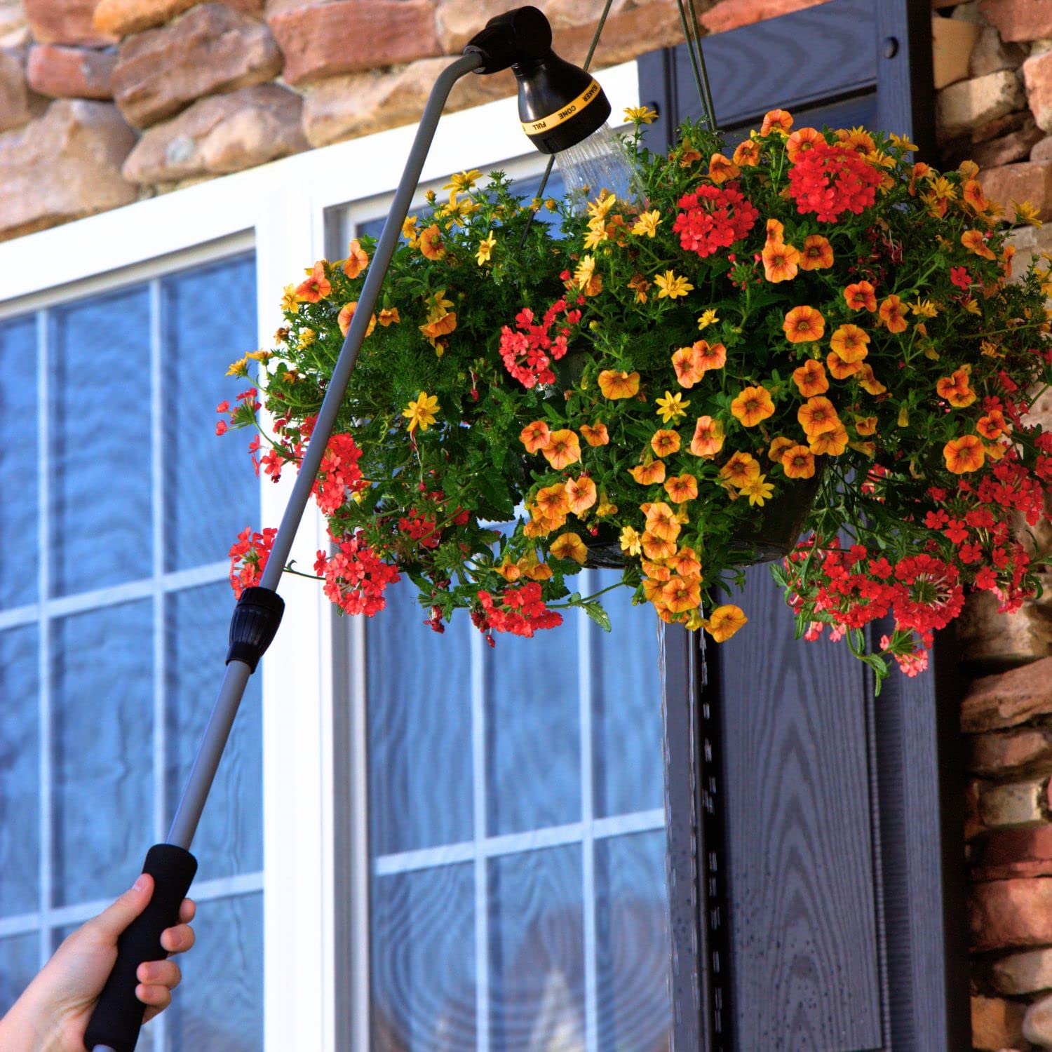 Melnor RelaxGrip extended in garden to water hanging plants, longer reach reduces stretching benefit
