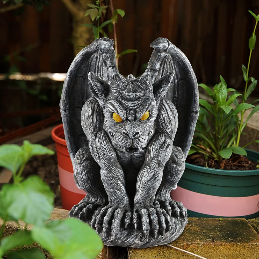 MIBUNG gargoyle lit at night with glowing eyes and tail for ambiance