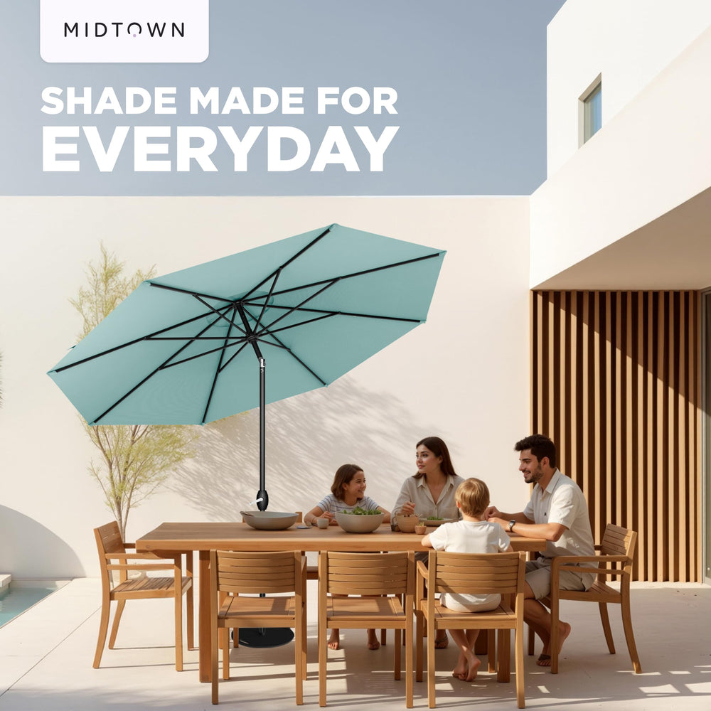 Midtown Umbrellas beside chair for scale showing 9 ft coverage benefit