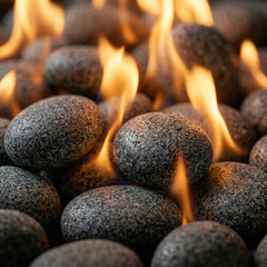 Midwest Hearth stones held in hand illustrating small 1/2–1 inch size and coverage benefit