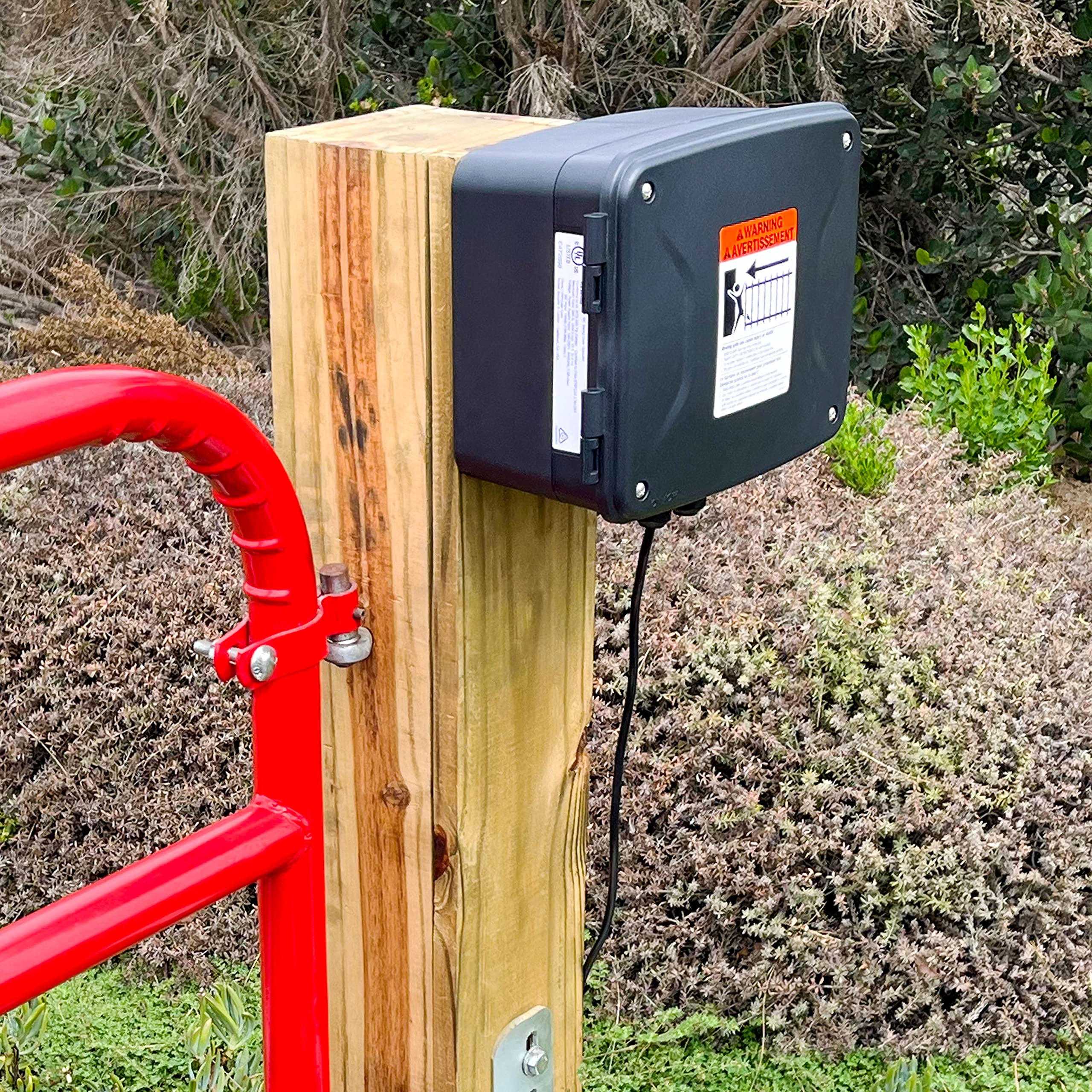 Mighty Mule enclosure mounted on chain link fence demonstrating sturdy outdoor placement benefit