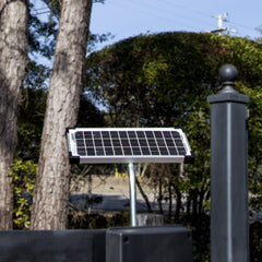 Mighty Mule 10W panel installed on a fence post powering gate opener and saving electricity