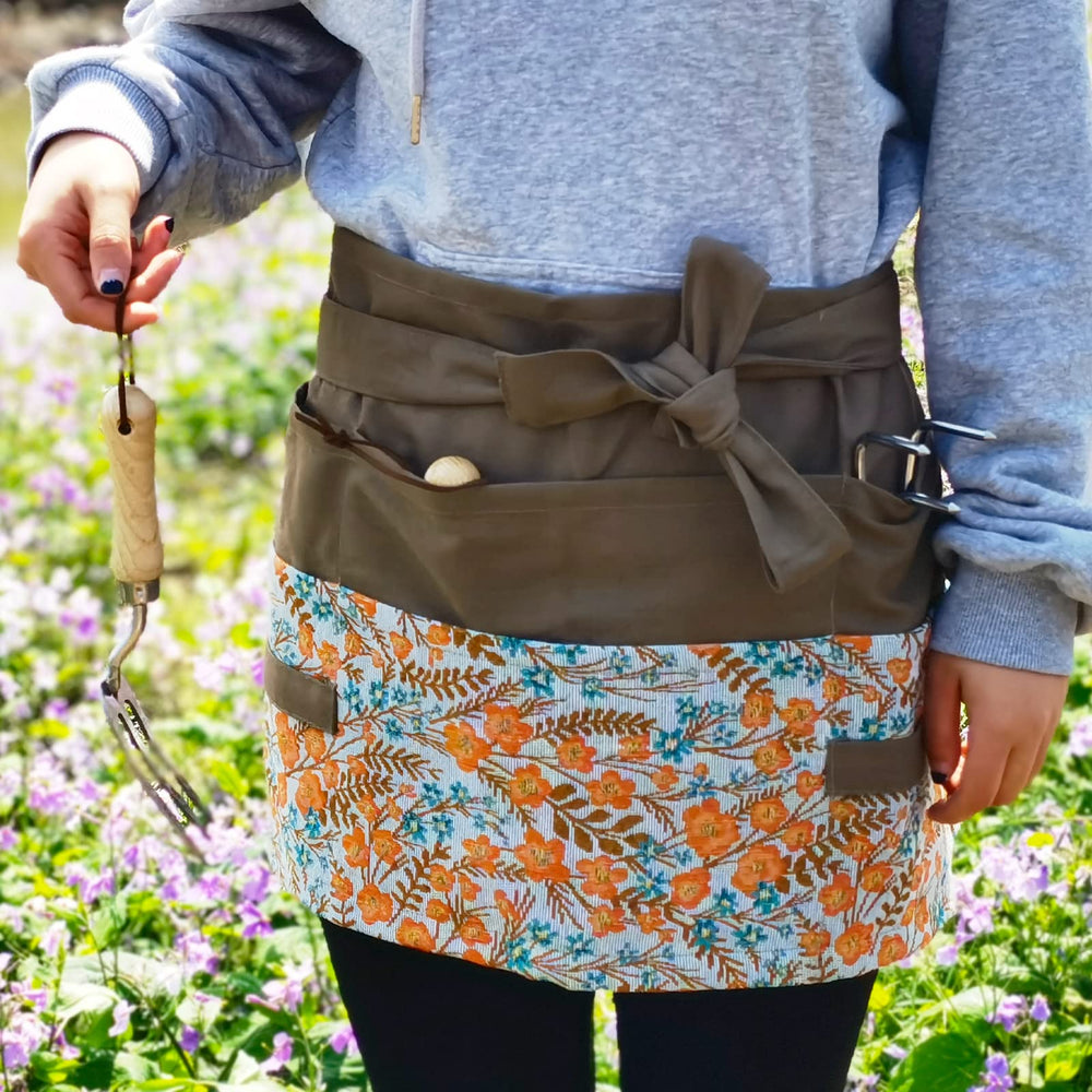 MILCIL apron worn while gardening showing tool access and clothing protection