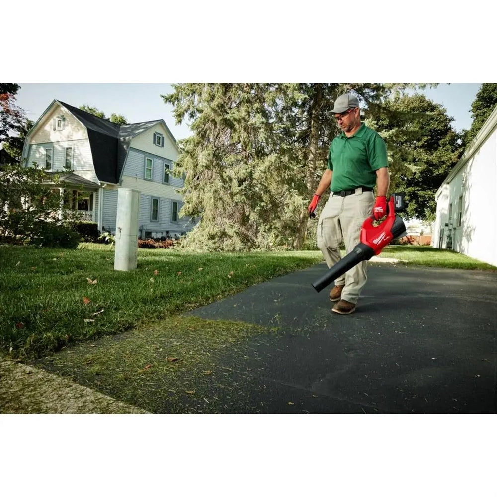 Milwaukee M18 FUELTRADE Blower held by hand to show scale and lightweight handling benefit