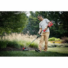 Milwaukee trimmer in use cutting overgrown grass to speed yard cleanup