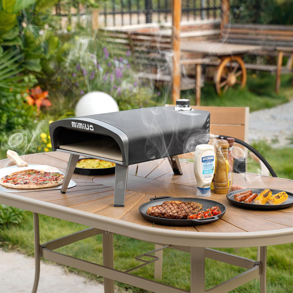 Mimiuo oven in use at a backyard party showing fast pizzas and social outdoor cooking