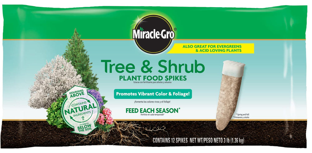 Miracle-Gro gardener inserting a spike into soil showcasing easy seasonal application