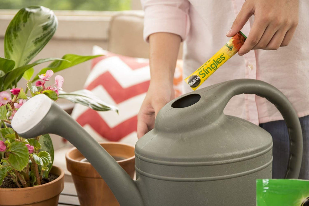 Miracle-Gro packet dissolving in a watering can for instant use