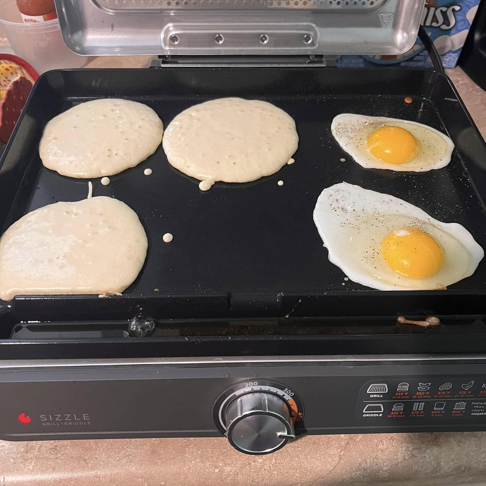 MOASKER griddle cooking eggs and pancakes demonstrating versatile, nonstick breakfast performance