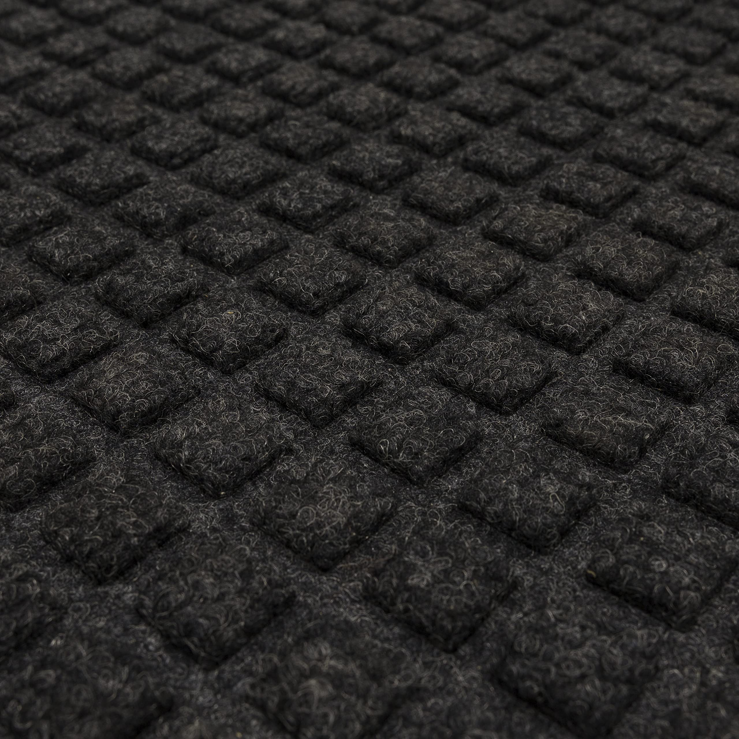 Mohawk Home mat next to foot for scale showing compact 2x3 size and low profile