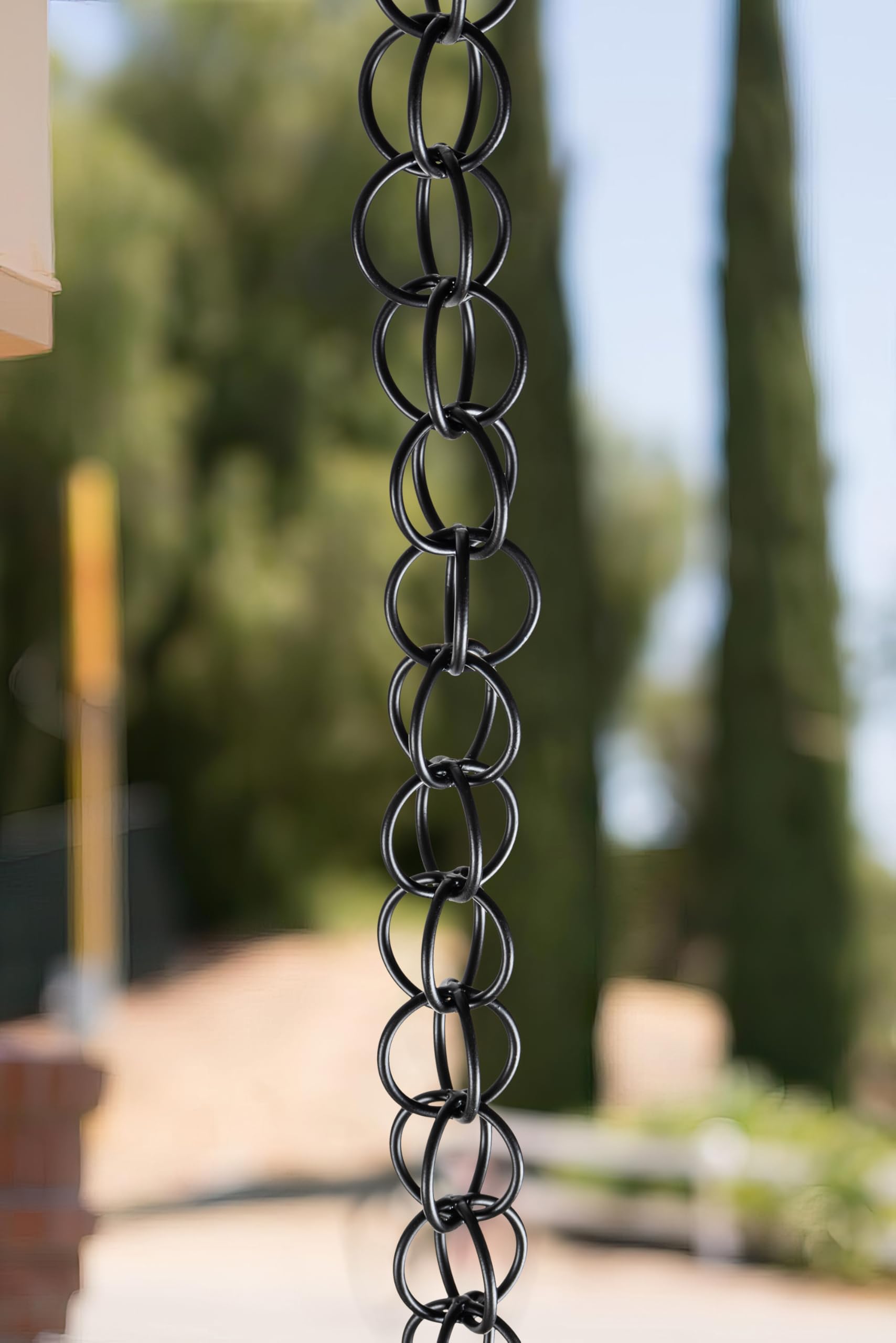 Monarch Rain Chains installed on gutter by porch showing easy tool-free mounting and elegant water flow