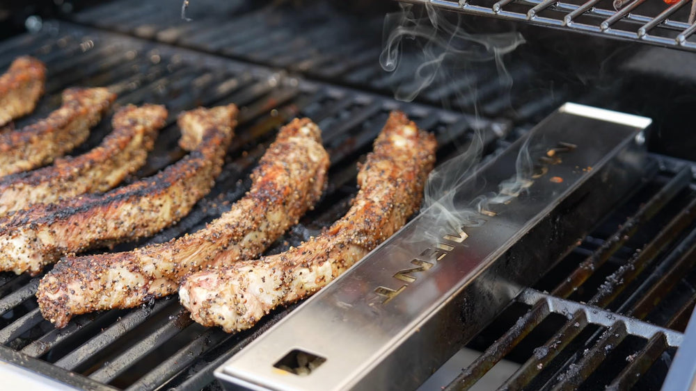 Monument Grills smoker box in backyard setting adding smoke to food for tastier results