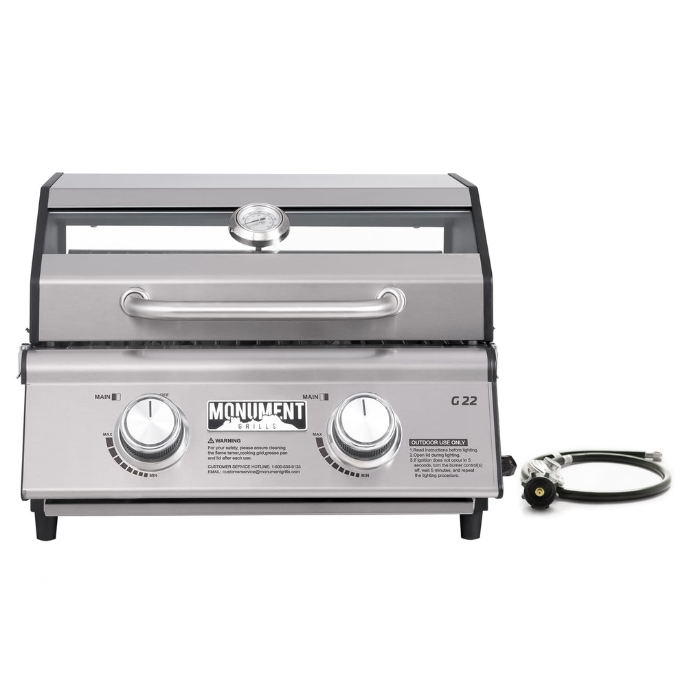 Monument Grills front view showing compact stainless-steel body and grilling surface for portability