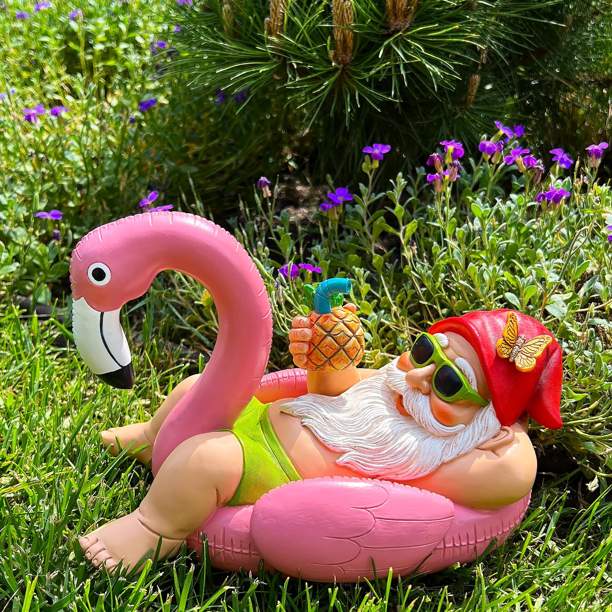 Mood Lab gnome flamingo tucked in garden bed enhancing plant display