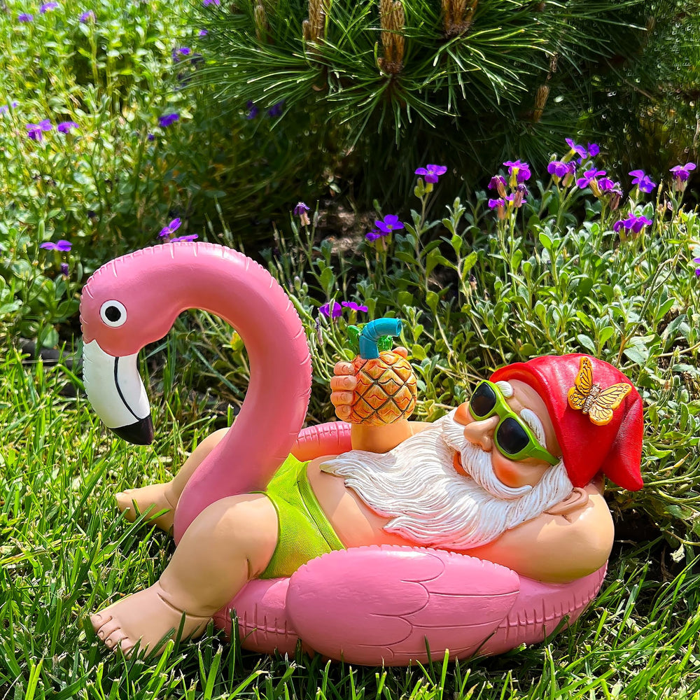 Mood Lab gnome flamingo tucked in garden bed enhancing plant display