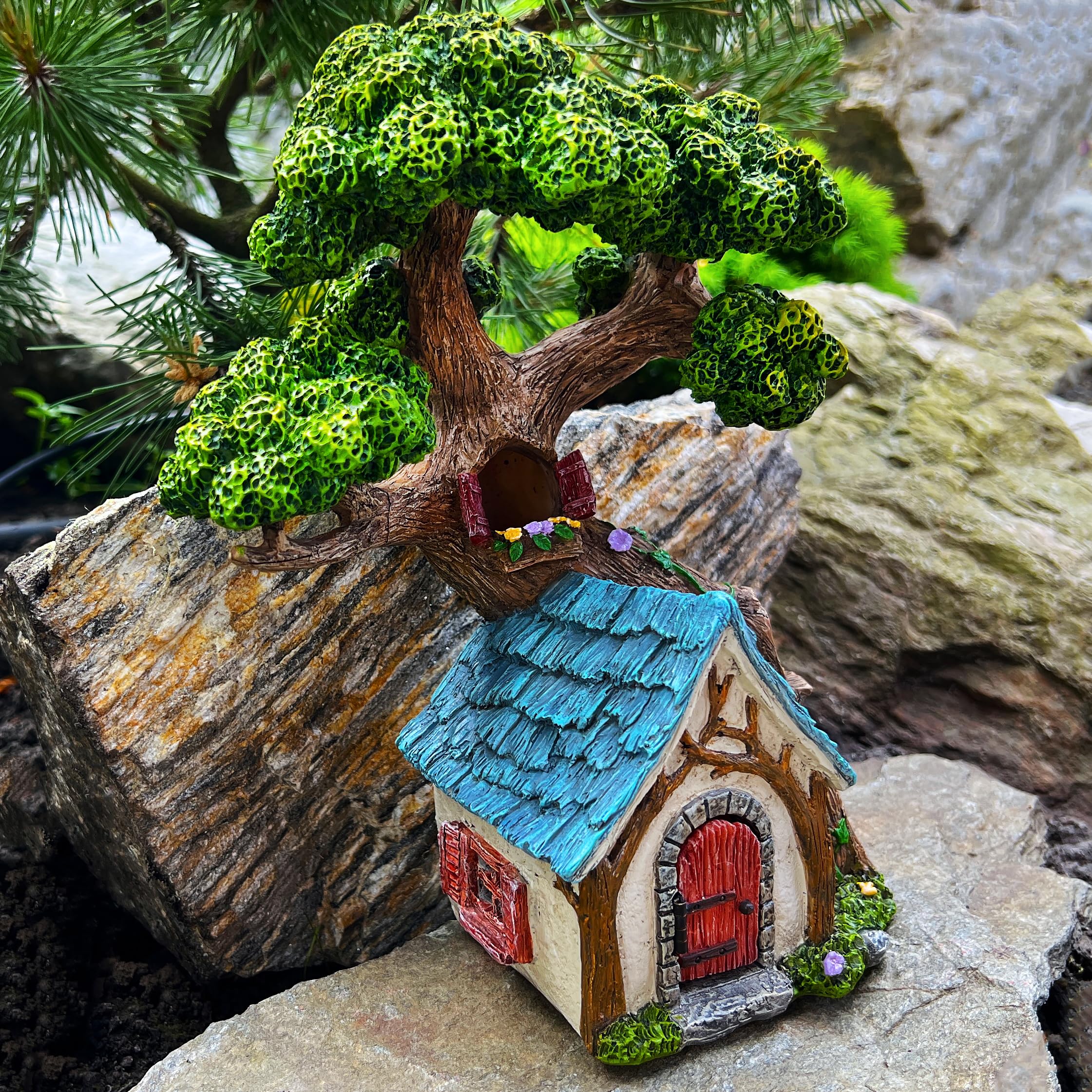 Mood Lab tree house beside fairy figurines to create a cohesive miniature scene