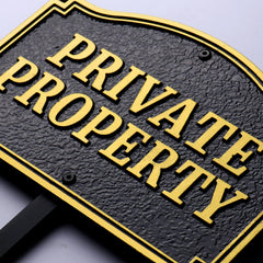 Morgtta front view of cast metal plaque showing bold private property message and durability