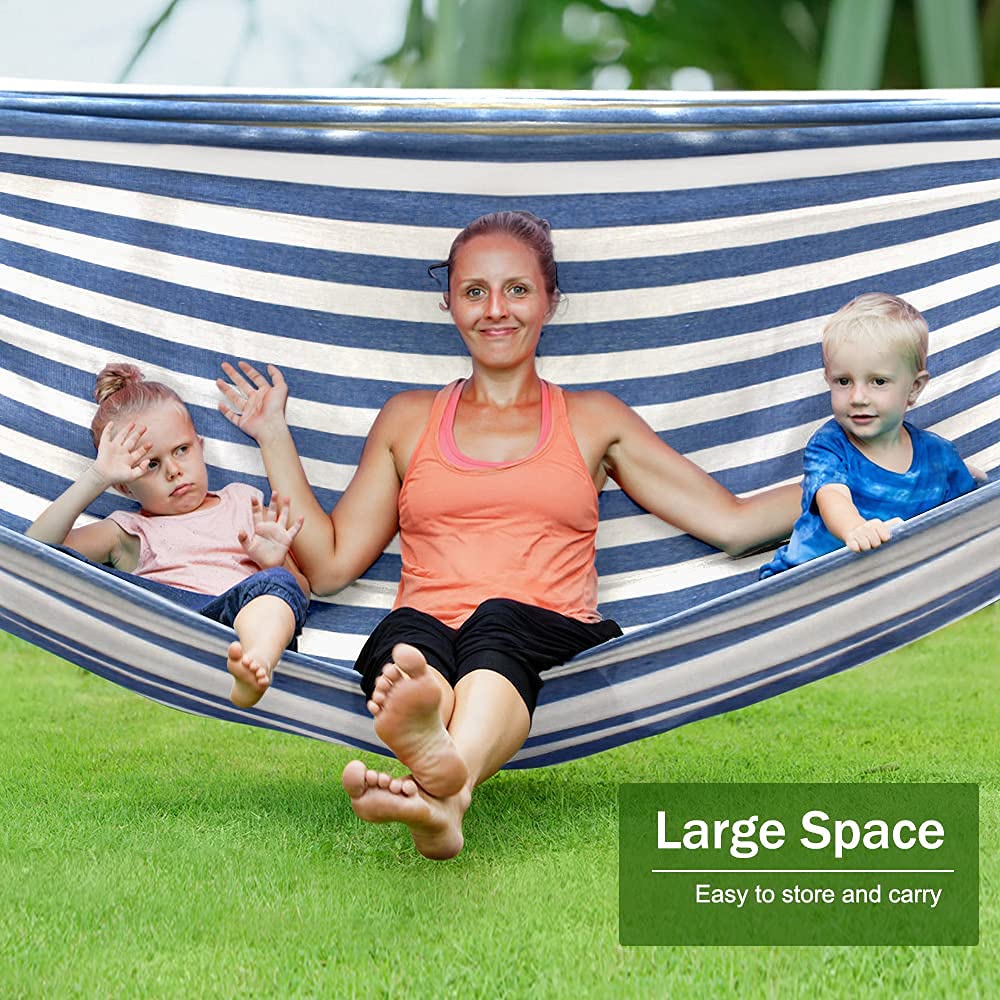 MOSFiATA hammock beside person showing scale and roomy 80.7 by 61 inch bed