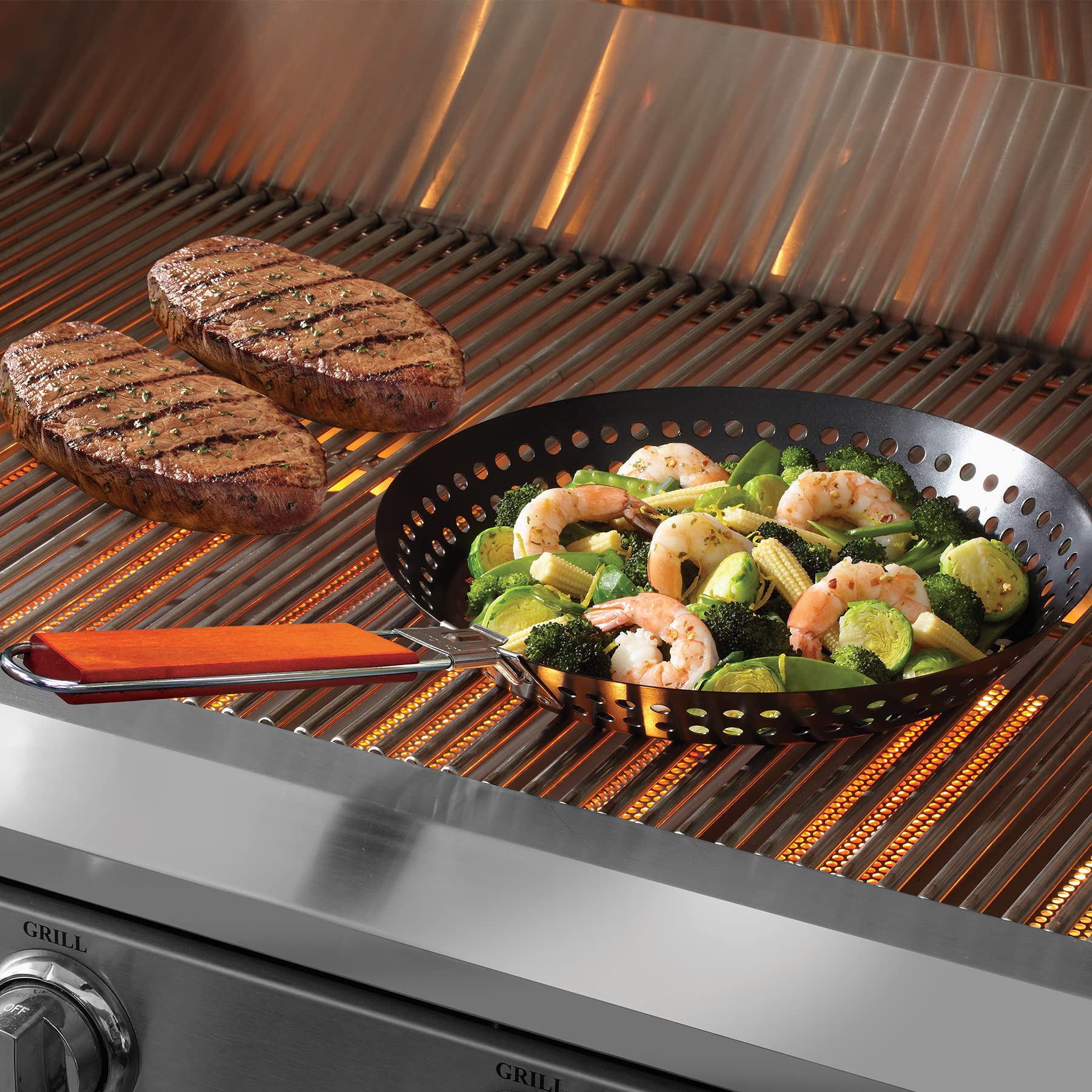 mr. bar-b-q skillet placed on charcoal grill showing reliable heat distribution outdoors