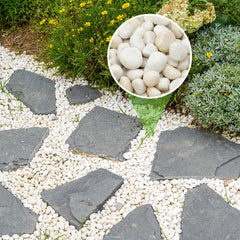 Mr. Fireglass pebbles spread as aquarium bed enhancing fish colors and visibility