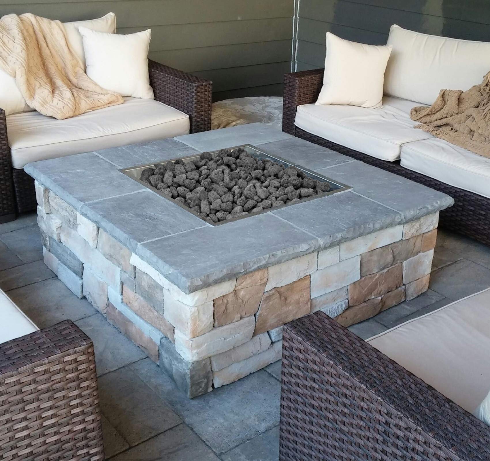 Mr. Fireglass hand holding 0.8–1.2 inch pieces to show size and easy placement