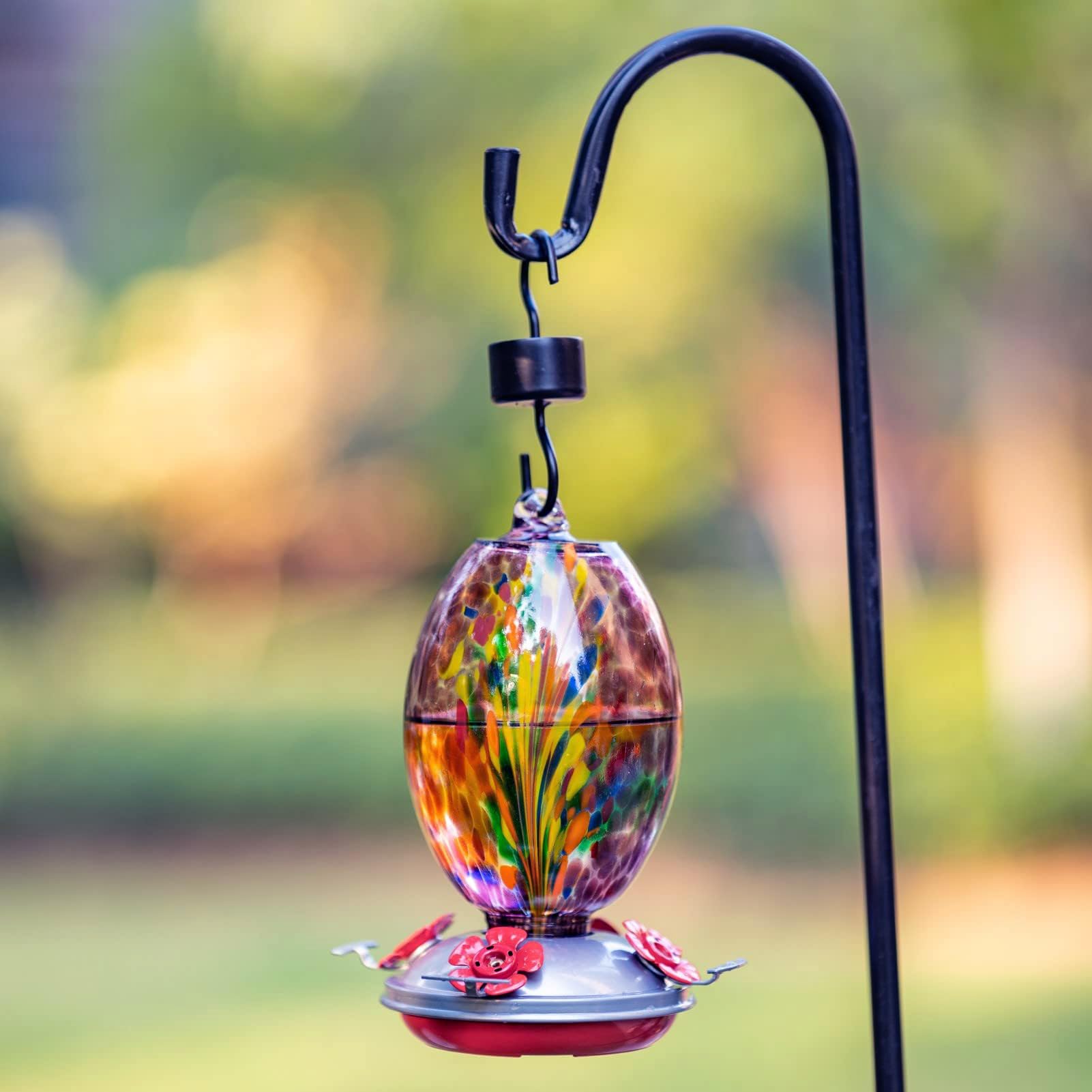 Muse Garden feeder hanging in garden to attract hummingbirds and beautify outdoor space