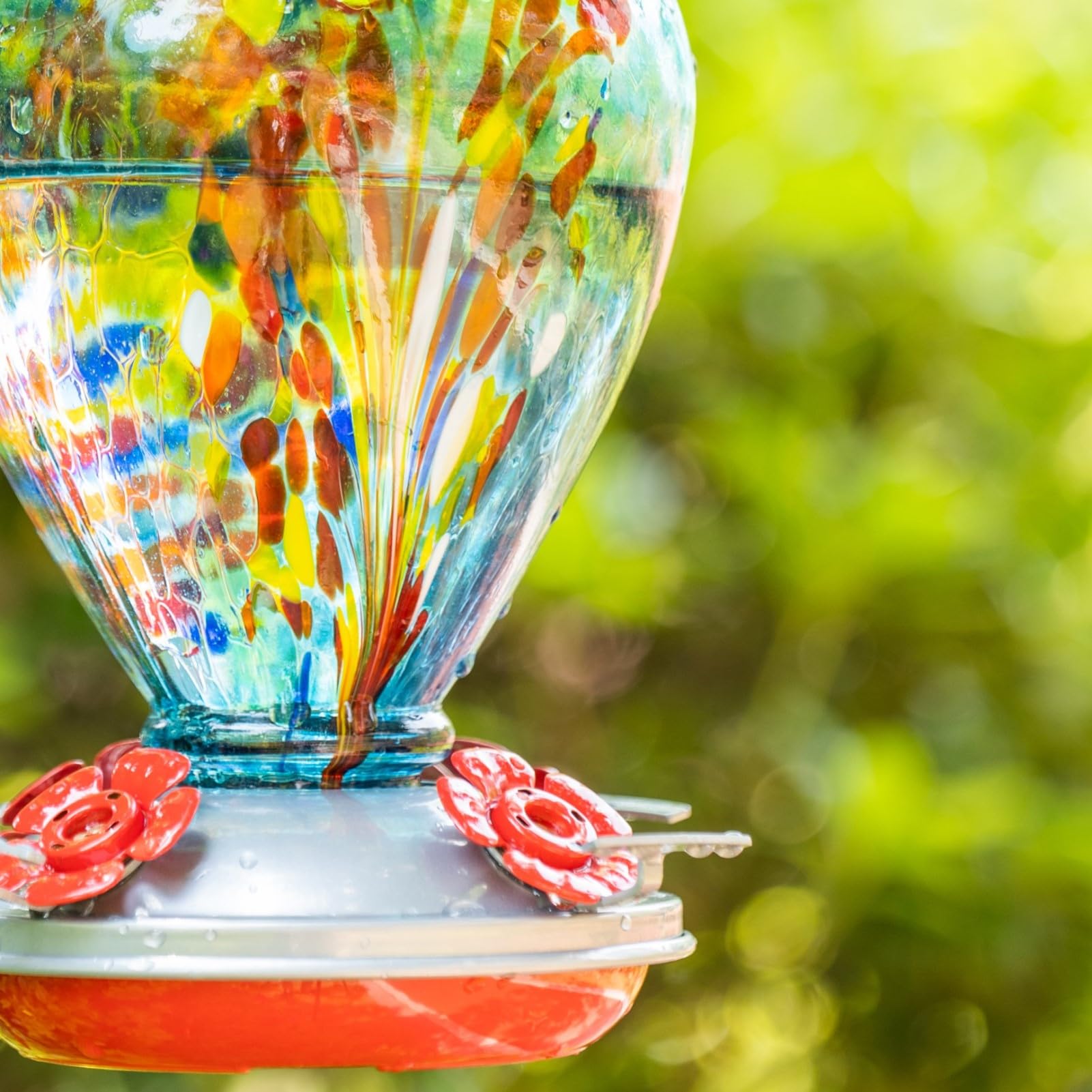 Muse Garden Nebula feeder front view highlighting unique glass pattern and charm