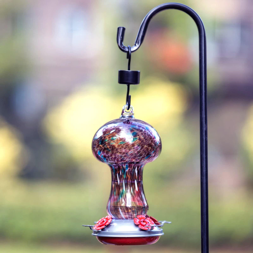 Muse Garden feeder beside hand to show 28oz scale, useful for sizing choice