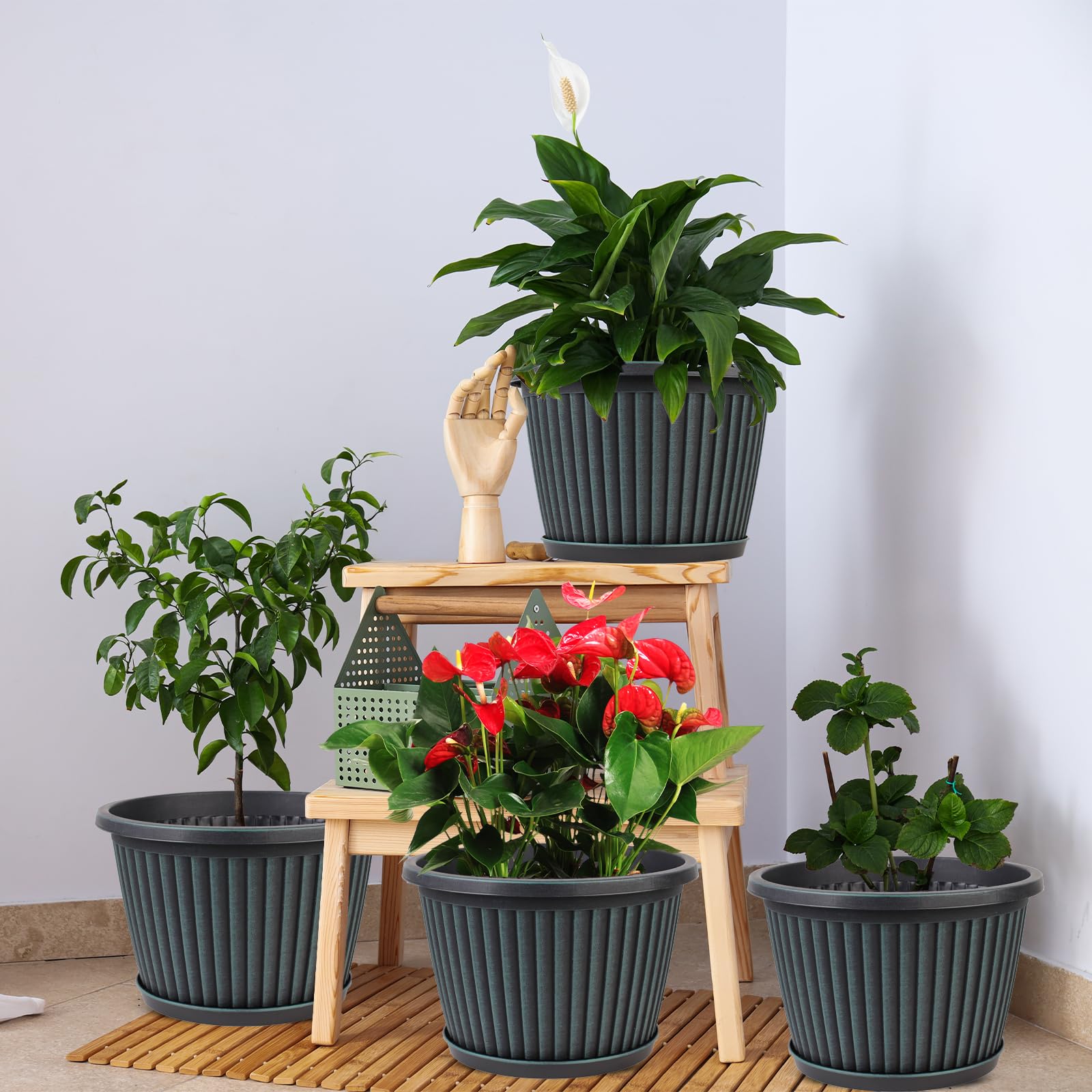 Myfeegoin planters arranged on a patio with mixed plants showing weather-resistant outdoor use benefit
