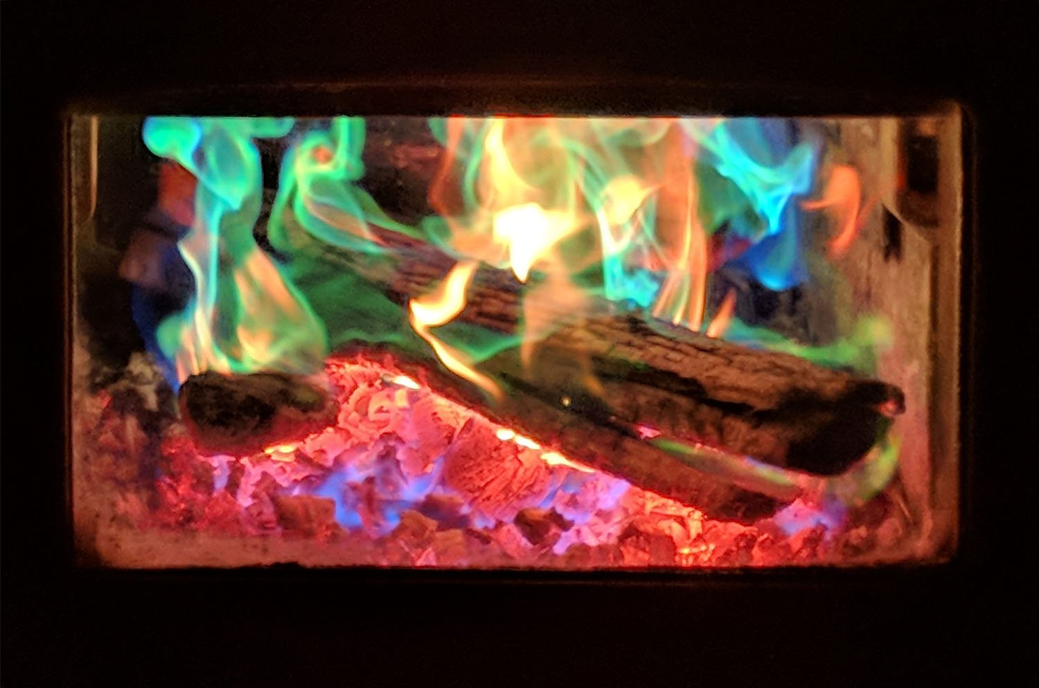 Mystical Fire flames with blue and green hues creating vibrant visual effect