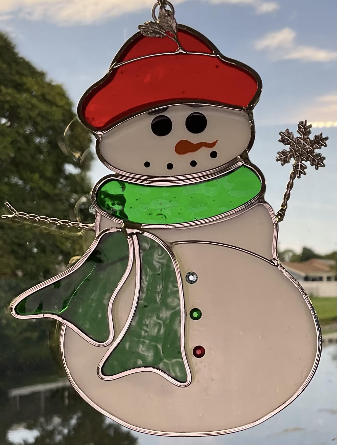 N2 snowman hanging in window casting colorful reflections for vibrant room lighting