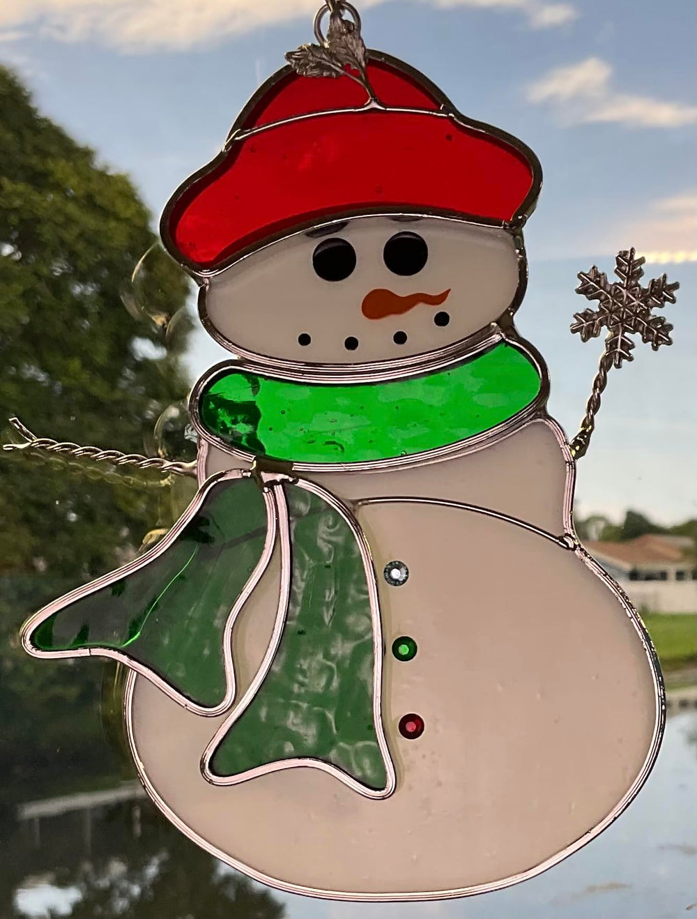 N2 snowman hanging in window casting colorful reflections for vibrant room lighting