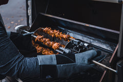 Napoleon unit installed on a spit rod demonstrating compatibility and hands-off cooking