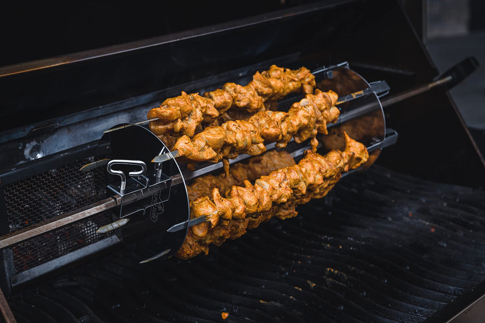 Napoleon skewers loaded with vegetables and meat cooking evenly on a grill