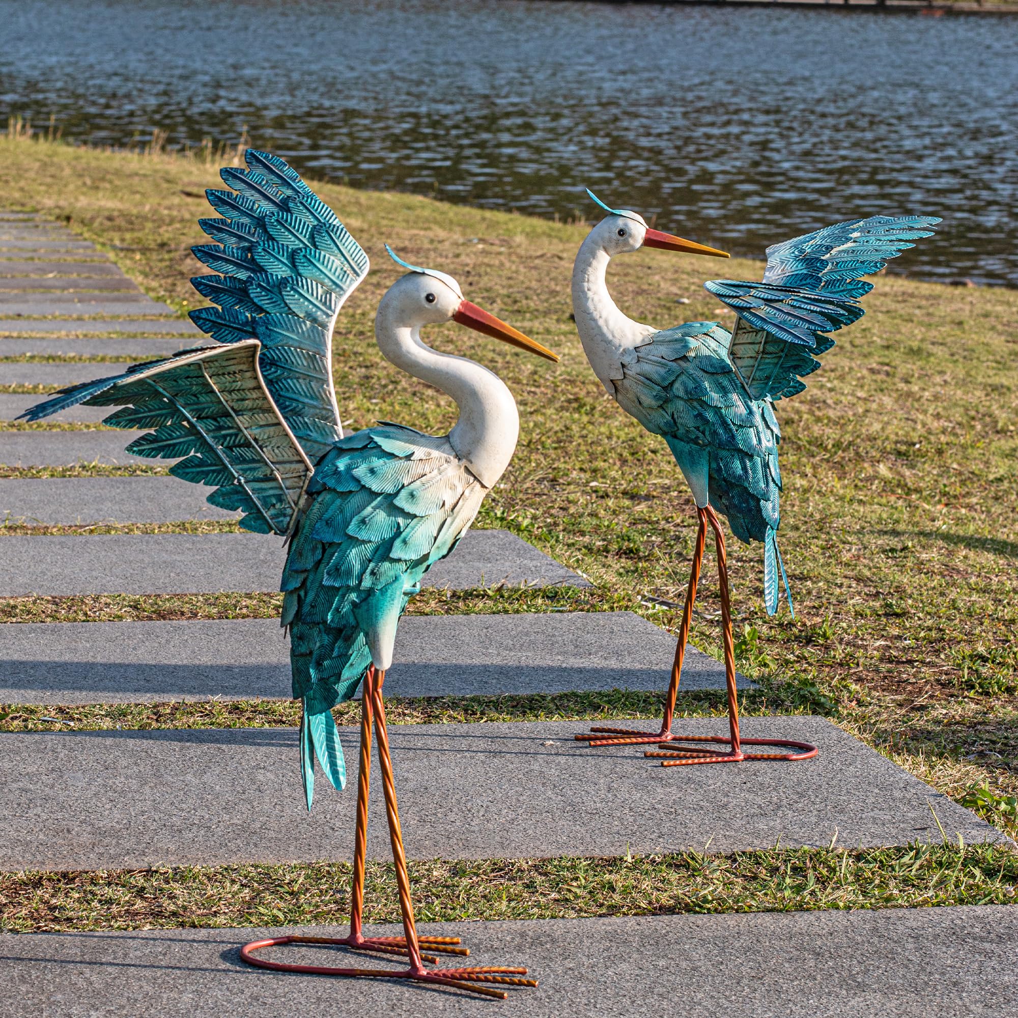 Natelf front view of paired heron statues showing graceful posture and garden appeal