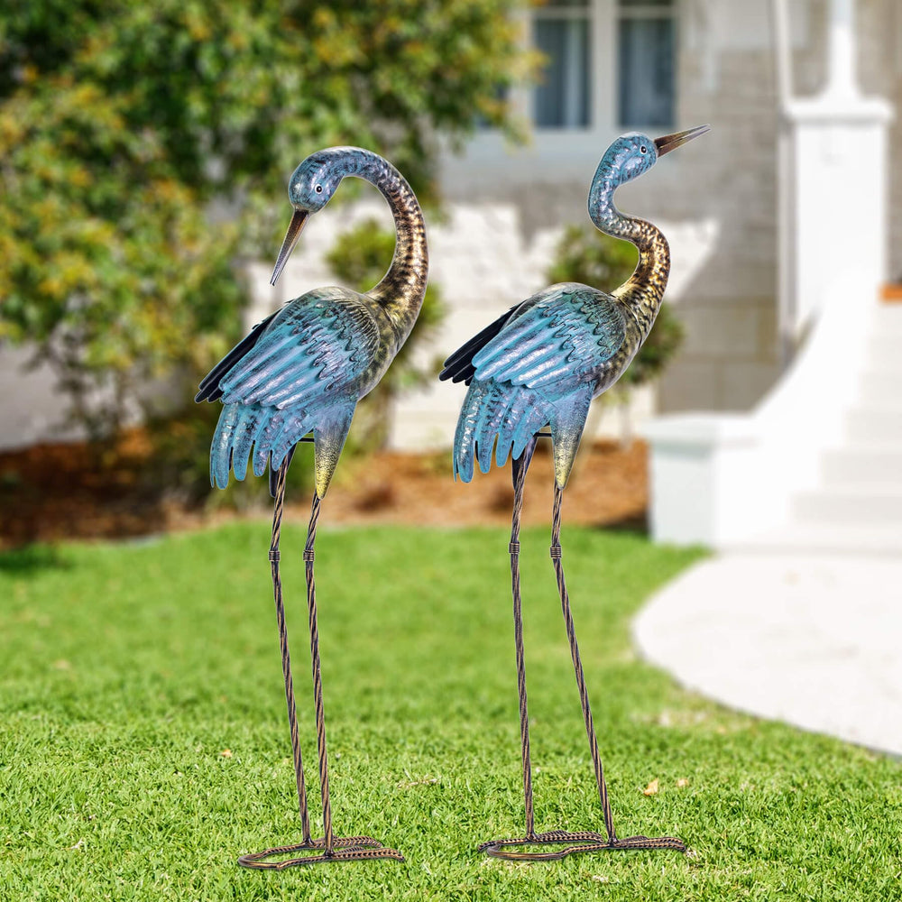 Natelf two herons staged in flower beds showing complementary poses and visual interest