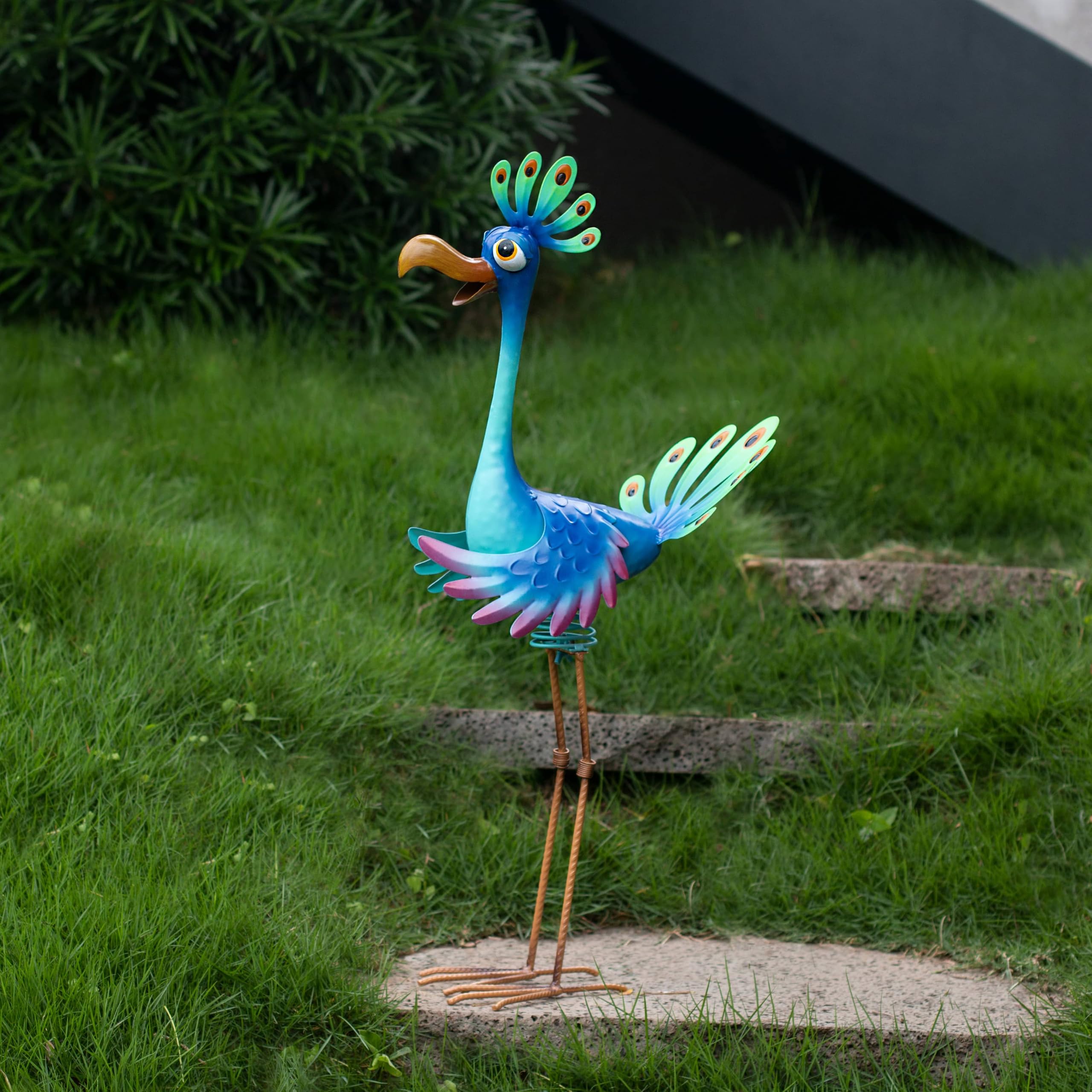 Natelf peacock next to chair showing scale and space-friendly size