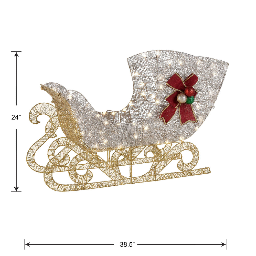 National Tree Company sleigh next to chair for scale, showing compact, visible size