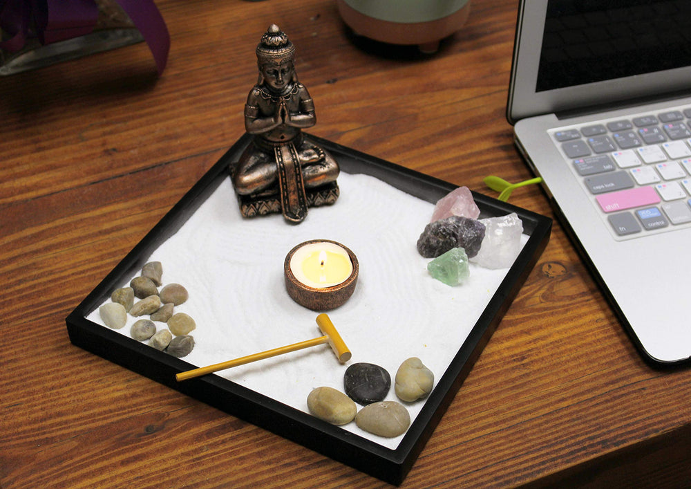 Nature's Mark Buddha figures with river rocks arranged for mindful focal points