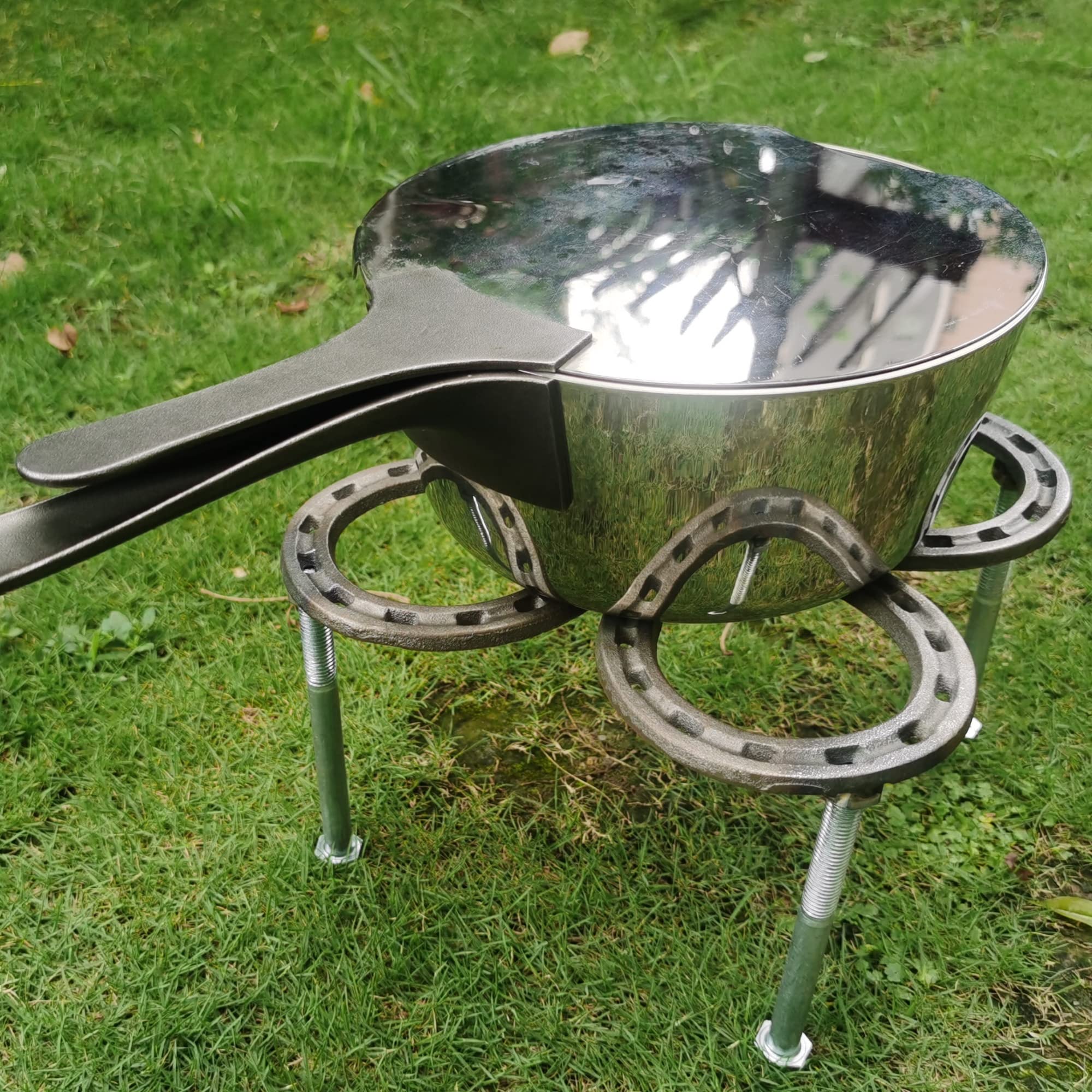 Nbguigdstr tripod over campfire in use indicating even heat control and stability