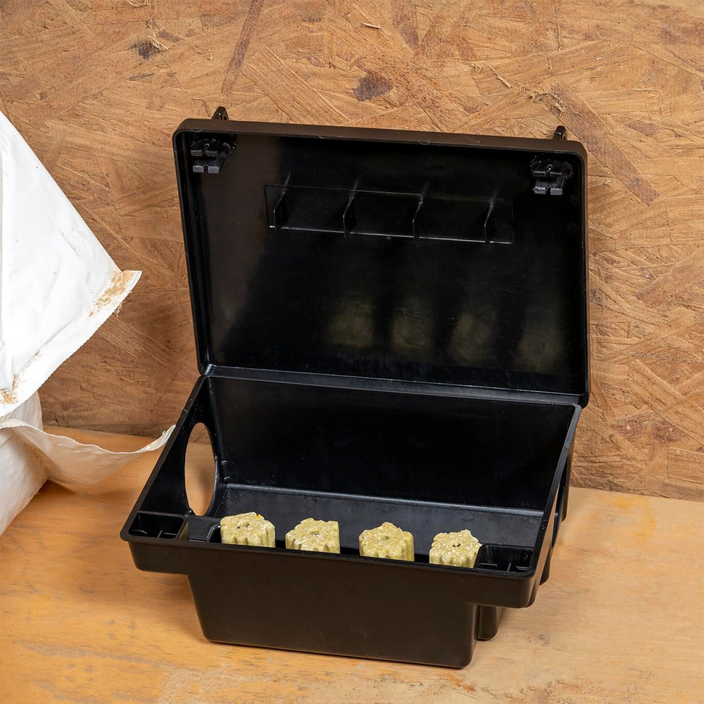 Neogen bait station placed in garage demonstrating concealed, safe baiting