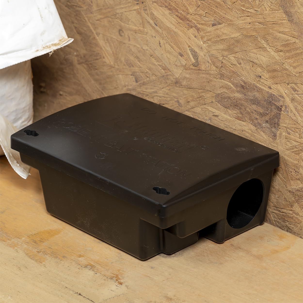 Neogen bait station next to ruler showing compact size for flexible placement