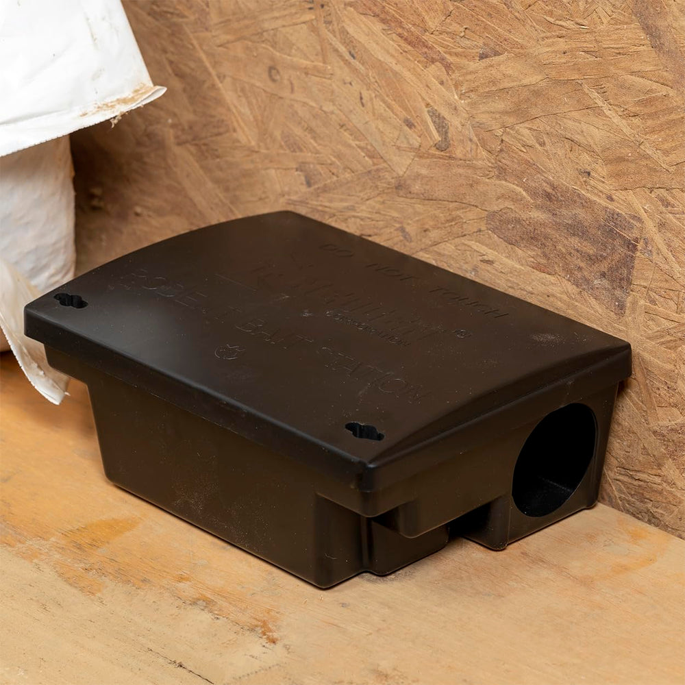 Neogen bait station next to ruler showing compact size for flexible placement