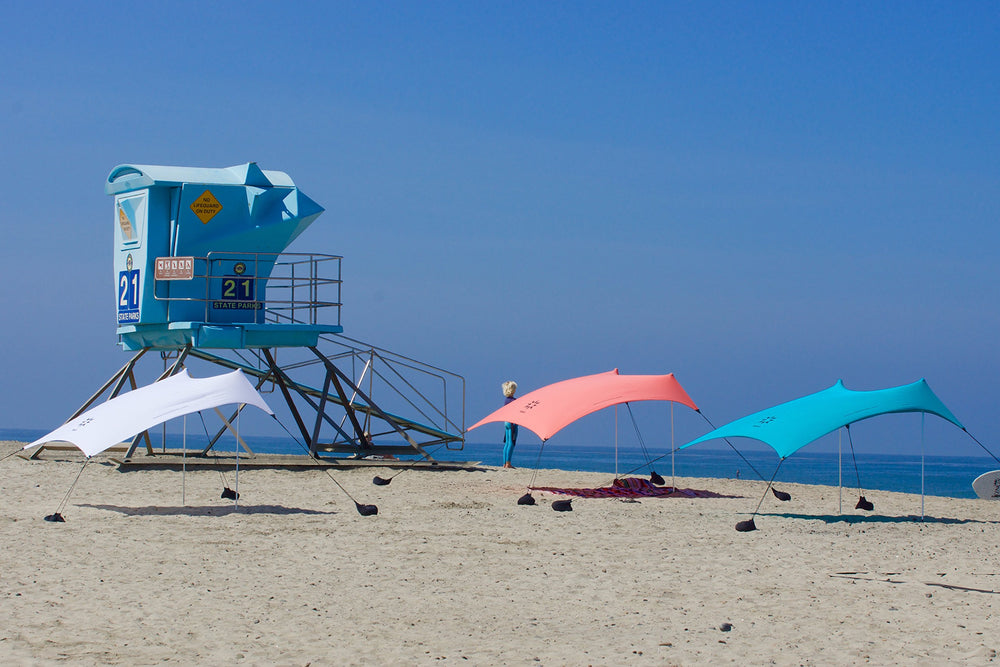 Neso tent beside a beach chair showing 7x7ft size and scale