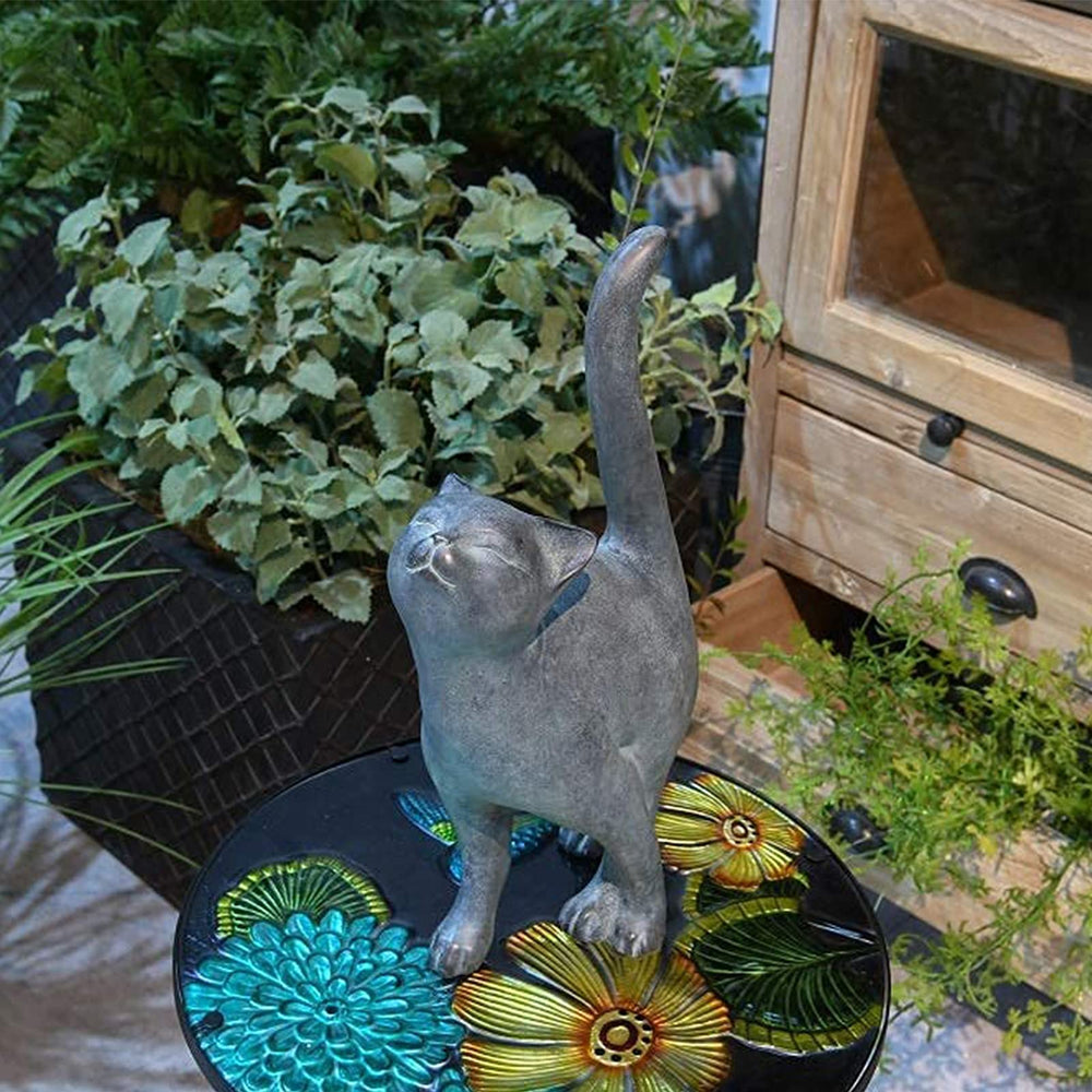 Newman House Studio kitten statue placed among garden plants offering outdoor accent appeal