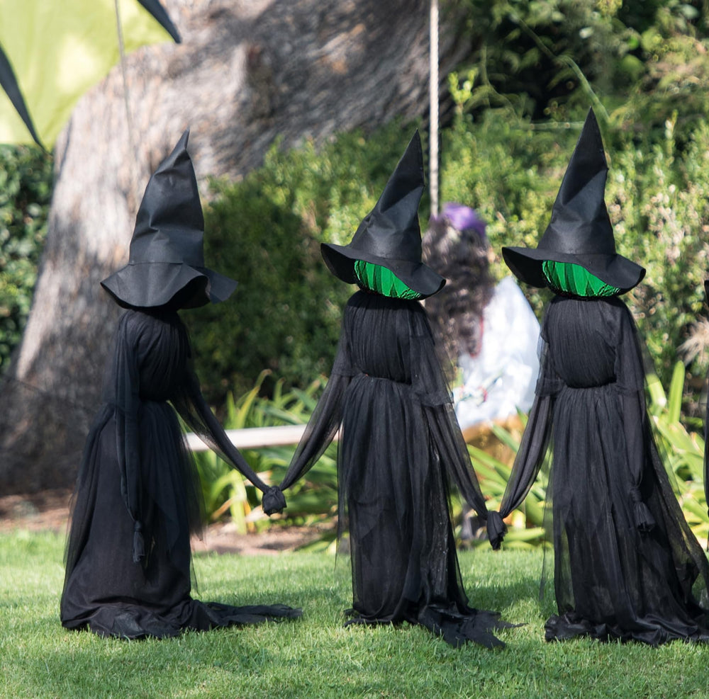 NIGHT-GRING front view of three witches holding hands for dramatic yard impact