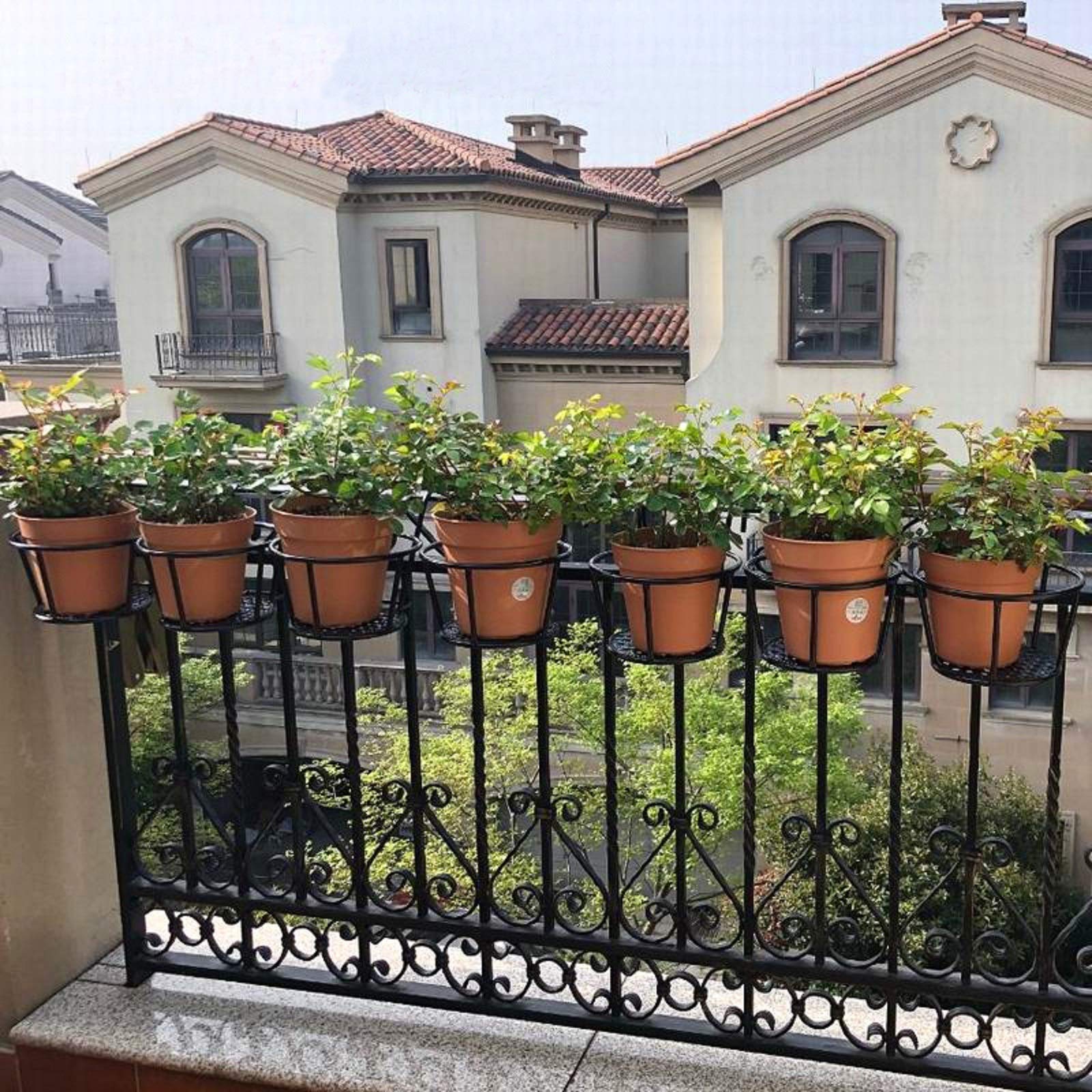 NILICAN hanger attached to a balcony rail showing easy tool-free installation benefit