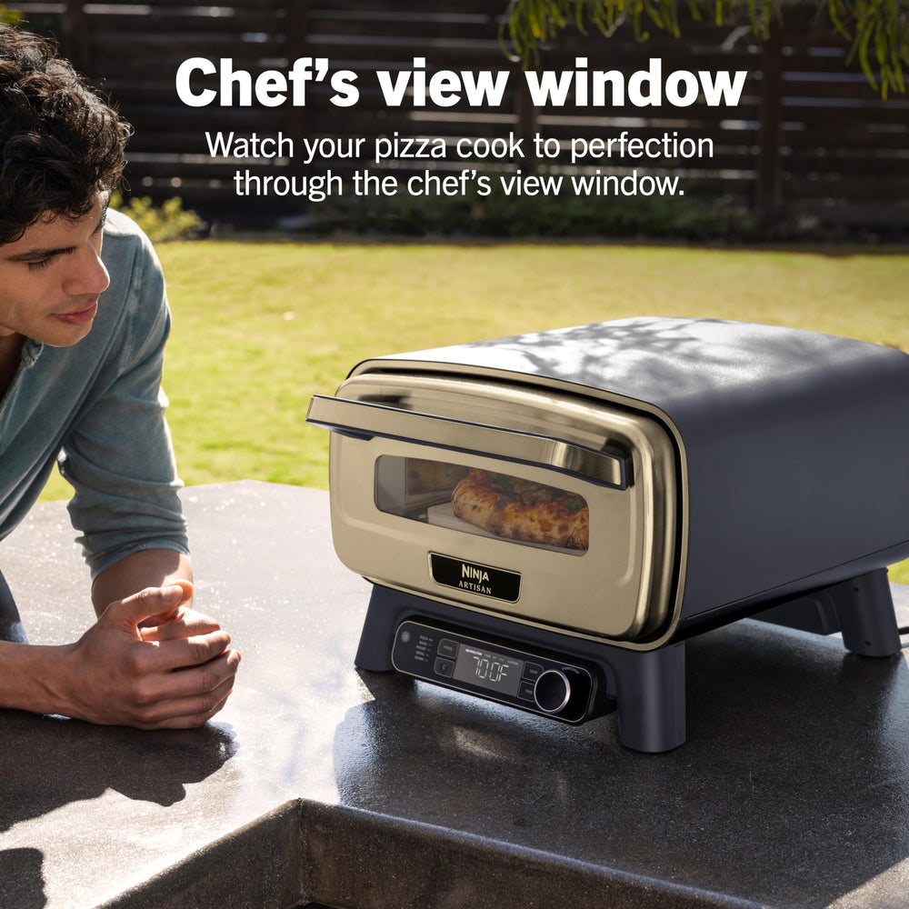 Included 12x12 pizza stone and quick start guide beside Ninja Artisan oven box and tools