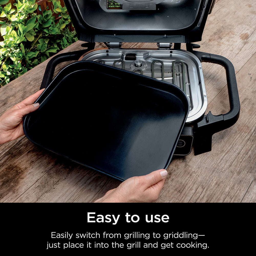 Ninja griddle next to spatula and plate showing size and cooking area for family meals