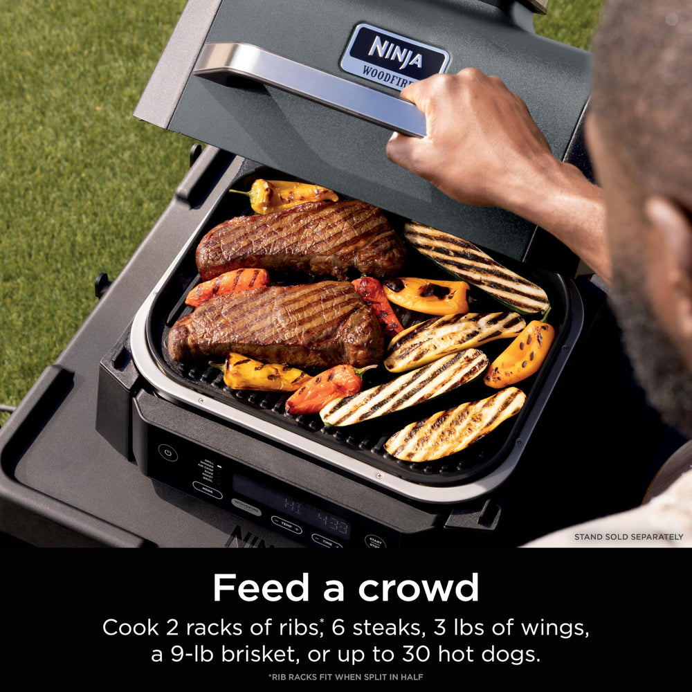 Ninja Woodfire open grill searing steaks for rich char and faster cooking